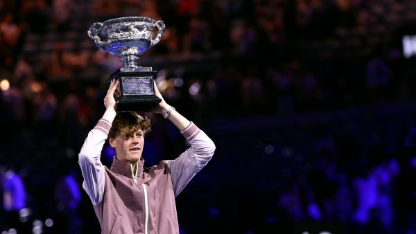 Italy's Jannik Sinner celebrates with the Norman Brookes Challenge Cup trophy after defeating Russia's Daniil Medvedev in the men's singles final match on day 15 of the Australian Open tennis tournament in Melbourne on January 28, 2024. (Photo by David GRAY / AFP) 