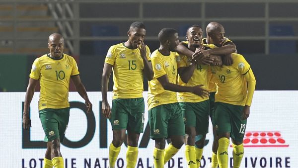 South Africa's defender #12 Thapelo Maseko celebrates with teammates after scoring his team's fourth goal during the Africa Cup of Nations (CAN) 2024 group E football match between South Africa and Namibia at Amadou Gon Coulibaly Stadium in Korhogo on January 21, 2024. (Photo by Fadel Senna / AFP)