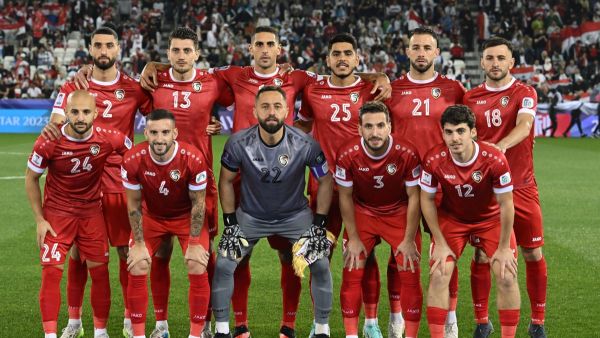 Syria's starting eleven pose for the group photo before the start of the Qatar 2023 AFC Asian Cup Group B football match between Uzbekistan and Syria at the Jassim bin Hamad Stadium in Doha on January 13, 2024. (Photo by HECTOR RETAMAL / AFP)