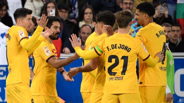 Barcelona players celebrate their second goal scored by Barcelona's German midfielder #22 Ilkay Gundogan (2L) during the Spanish league football match between Deportivo Alaves and FC Barcelona at the Mendizorroza stadium in Vitoria on February 3, 2024. (Photo by Ander Gillenea / AFP)