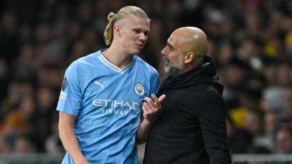 Manchester City's Norwegian forward #09 Erling Haaland (L) speaks with Manchester City's Spanish head coach Pep Guardiola during the UEFA Champions League Group G football match between Young Boys (SUI) and Manchester City (ENG) at The Wankdorf Stadium, in Bern on October 25, 2023. (Photo by Fabrice COFFRINI / AFP)