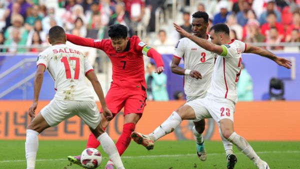 Jordan's defender #23 Ehsan Haddad vies for the ball against South Korea's midfielder #07 Son Heung-min during the Qatar 2023 AFC Asian Cup Group E football match between Jordan and South Korea at the Al-Thumama Stadium in Doha on January 20, 2024. (Photo by Giuseppe CACACE / AFP)