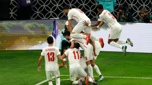 Jorda's players celebrate their second goal during the Qatar 2023 AFC Asian Cup semi-final football match between Jordan and South Korea at the Ahmad Bin Ali Stadium in Al-Rayyan, west of Doha on February 6, 2024. (Photo by KARIM JAAFAR / AFP)