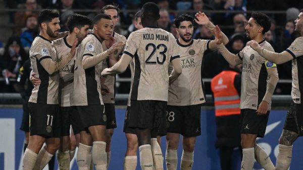 Paris Saint-Germain's Spanish forward #11 Marco Asensio (L) is congratulated by teammates after scoring a goal during the French L1 football match between RC Strasbourg (RCS) and Paris Saint-Germain (PSG) at the Meinau stadium in Strasbourg, on February 2, 2024. (Photo by PATRICK HERTZOG / AFP)
