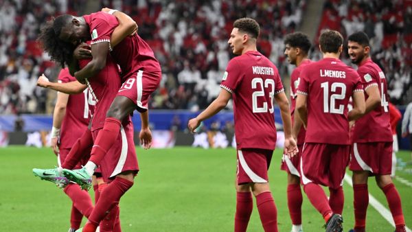 Qatar's forward #11 Akram Afif (L) celebrates with teammates after scoring his team's first goal during the Qatar 2023 AFC Asian Cup Group A football match between Tajikistan and Qatar at the Al-Bayt Stadium in Al Khor, north of Doha on January 17, 2024. (Photo by HECTOR RETAMAL / AFP)