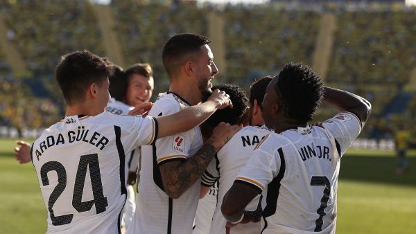 Real Madrid's French defender #18 Aurelien Tchouameni celebrates with teammates after scoring his team's second goal during the Spanish league football match between UD Las Palmas and Real Madrid CF at the Gran Canaria stadium in Las Palmas de Gran Canaria on January 27, 2024. (Photo by DESIREE MARTIN / AFP)