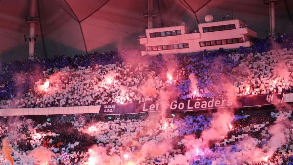 Supporters cheer in the stands during the Saudi Pro League football match between Al-Hilal and Al-Nassr at the King Fahd International Stadium in Riyadh on December 1, 2023. (Photo by Fayez NURELDINE / AFP)