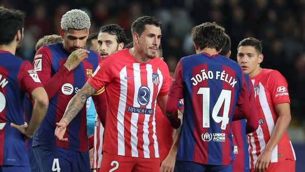 Atletico Madrid's Uruguayan defender #02 Jose Gimenez talks with Barcelona's Portuguese forward #14 Joao Felix during the Spanish league football match between FC Barcelona and Club Atletico de Madrid at the Estadi Olimpic Lluis Companys in Barcelona on December 3, 2023. (Photo by LLUIS GENE / AFP)
