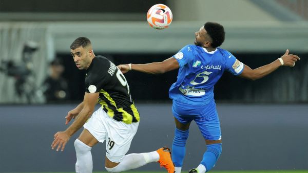 Hilal's Saudi defender #05 Ali al-Bulaihi and Ittihad's Moroccan forward #99 Abderrazak Hamdallah vie for the ball during the Saudi Pro League football match between Al-Ittihad and Al-Hilal at Prince Abdullah al-Faisal Stadium in Jeddah on September 1, 2023. (Photo by AFP)