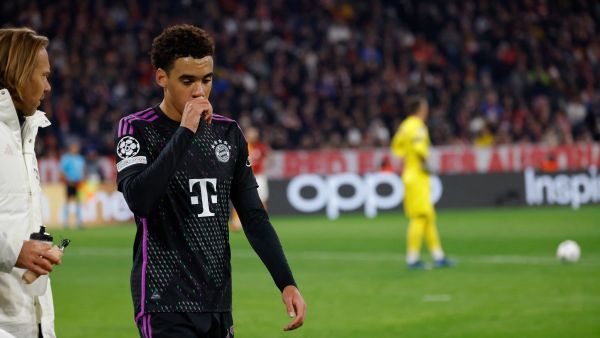 Bayern Munich's German midfielder #42 Jamal Musiala (R) receives medical attention after sustaining an injury during the UEFA Champions League Group A football match between FC Bayern Munich and Galatasaray AS in Munich, southern Germany on November 8, 2023. (Photo by MICHAELA REHLE / AFP)