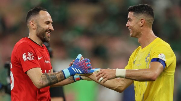Nassr's Portuguese forward #07 Cristiano Ronaldo celebrates with Nassr's Colombian goalkeeper #26 David Ospina after the Saudi Pro League football match between Al-Ahli and Al-Nassr at the King Abdullah Sport City Stadium in Jeddah on March 15, 2024. (Photo by AFP)