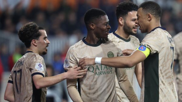 Paris Saint-Germain's Portuguese defender #02 Nuno Mendes (C) celebrates with Paris Saint-Germain's French forward #07 Kylian Mbappe (R) and Paris Saint-Germain's Portuguese midfielder #17 Vitinha (L) after scoring his team's sixth goal during the French L1 football match between Montpellier Herault SC and Paris-Saint-Germain (PSG) at Stade de la Mosson in Montpellier, southern France, on March 17, 2024. (Photo by Pascal GUYOT / AFP)
