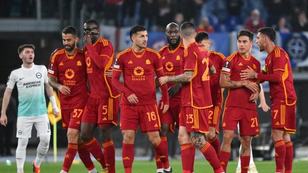 Roma's Argentine forward #21 Paulo Dybala (2R) is congratulated by teammates after scoring Roma's first goal during the UEFA Europa League last 16 first leg football match between AS Roma and Brighton and Hove Albion at the Olympic Stadium in Rome on March 7, 2024. (Photo by Andreas SOLARO / AFP)