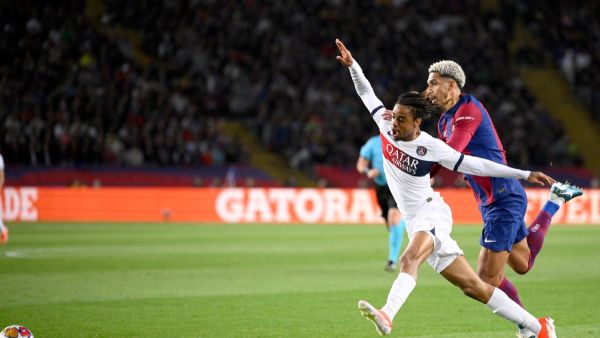 Paris Saint-Germain's French forward #29 Bradley Barcola fights for the ball with Barcelona's Uruguayan defender #04 Ronald Araujo during the UEFA Champions League quarter-final second leg football match between FC Barcelona and Paris SG at the Estadi Olimpic Lluis Companys in Barcelona on April 16, 2024. (Photo by Josep LAGO / AFP)
