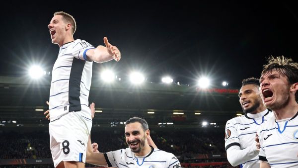 Atalanta's Croatian midfielder #08 Mario Pasalic (L) celebrates scoring the team's third goal during the UEFA Europa League quarter-final first leg football match between Liverpool and Atalanta at Anfield in Liverpool, north west England on April 11, 2024. (Photo by DARREN STAPLES / AFP)