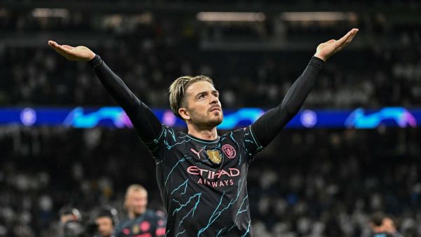 Manchester City's English midfielder #10 Jack Grealish celebrates at the end of the UEFA Champions League quarter final first leg football match between Real Madrid CF and Manchester City at the Santiago Bernabeu stadium in Madrid on April 9, 2024. (Photo by JAVIER SORIANO / AFP)