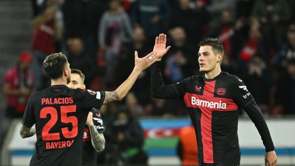 Bayer Leverkusen's Czech forward #14 Patrik Schick (C) celebrates scoring the 3-2 goal with team mate Bayer Leverkusen's Argentine midfielder #25 Exequiel Palacios during the UEFA Europa League Group round of 16, second-leg football match between Bayer 04 Leverkusen and Garabagh in Leverkusen, western Germany on March 14, 2024. (Photo by INA FASSBENDER / AFP)
