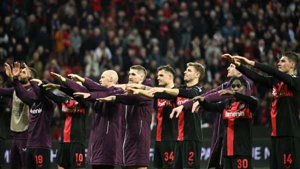 Bayer Leverkusen's players celebrate with fans at the end of the UEFA Europa League Group round of 16, second-leg football match between Bayer 04 Leverkusen and Garabagh in Leverkusen, western Germany on March 14, 2024. Bayer Leverkusen won the match 3-2. (Photo by INA FASSBENDER / AFP)