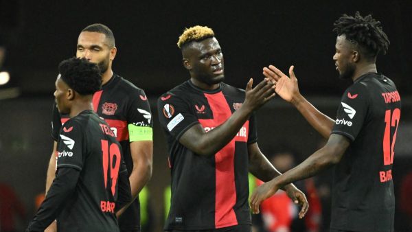 Bayer Leverkusen's Nigerian forward #22 Victor Boniface (2R) celebrates scoring his team's second goal with Bayer Leverkusen's Burkinabe defender #12 Edmond Tapsoba (R) and teammates Bayer Leverkusen's German defender #04 Jonathan Tah (2L) and Bayer Leverkusen's English midfielder #19 Nathan Tella during the UEFA Europa League quarter-final first leg football match between Bayer 04 Leverkusen and West Ham United FC in Leverkusen, western Germany on April 11, 2024. (Photo by INA FASSBENDER / AFP)