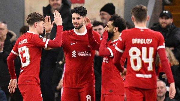 Liverpool's Hungarian midfielder #08 Dominik Szoboszlai celebrates scoring the team's fifth goal with Liverpool's English midfielder #53 James McConnell and Liverpool's Egyptian striker #11 Mohamed Salah during the UEFA Europa League round of 16 second leg football match between Liverpool and AC Sparta Praha at Anfield in Liverpool, north west England on March 14, 2024. (Photo by Oli SCARFF / AFP)