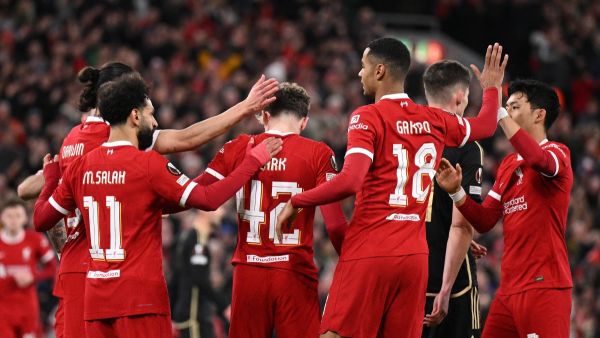 Liverpool's English midfielder #42 Bobby Clark (C) is mobbed by teammates after scoring the team's second goal during the UEFA Europa League round of 16 second leg football match between Liverpool and AC Sparta Praha at Anfield in Liverpool, north west England on March 14, 2024. (Photo by Oli SCARFF / AFP)