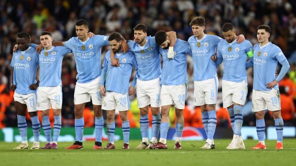 Manchester City players react during the penalty shootout during the UEFA Champions League quarter-final second-leg football match between Manchester City and Real Madrid, at the Etihad Stadium, in Manchester, north-west England, on April 17, 2024. (Photo by Darren Staples / AFP)