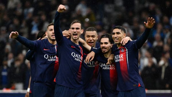 Paris Saint-Germain's Portuguese midfielder #17 Vitinha (2nd R) celebrates with teammates after scoring the opening goal during the French L1 football match between Olympique Marseille (OM) and Paris Saint-Germain (PSG) at Stade Velodrome in Marseille, southeastern France, on March 31, 2024. (Photo by CHRISTOPHE SIMON / AFP)