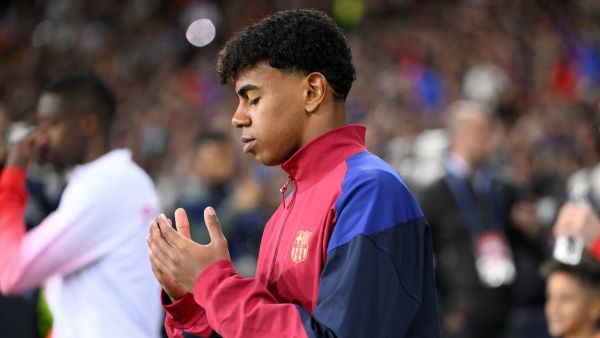 Barcelona's Spanish forward #27 Lamine Yamal prays as he enters the pitch during the UEFA Champions League quarter-final second leg football match between FC Barcelona and Paris SG at the Estadi Olimpic Lluis Companys in Barcelona on April 16, 2024. (Photo by Josep LAGO / AFP)