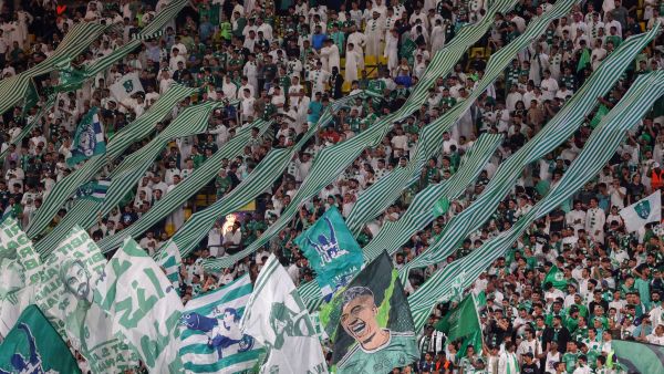 Ahli's supporters lift banners during the Saudi Pro League football match between Al-Nassr and Al-Ahli at the King Saud University Stadium in Riyadh, on September 22, 2023. (Photo by Fayez Nureldine / AFP)