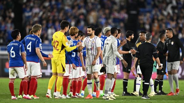 Yokohama (L) shake hands with Al Ain (R) at the end of the AFC Champions League final first leg football match between UAE's Al Ain and Japan's Yokohama F. Marinos at Nissan Stadium in Yokohama, Kanagawa prefecture, south of Tokyo, on May 11, 2024. (Photo by Philip FONG / AFP)