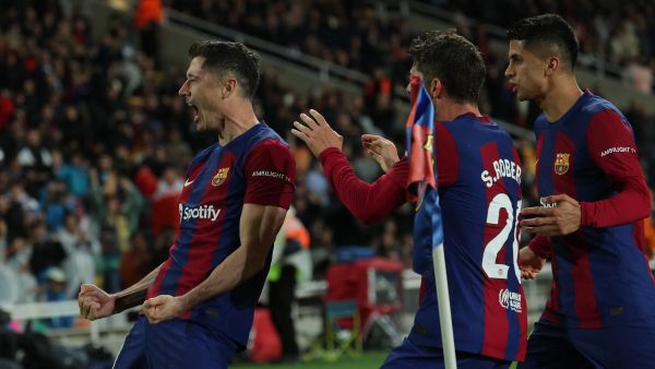 Barcelona's Polish forward #09 Robert Lewandowski celebrates with teammates after scoring his team's third goal during the Spanish league football match between FC Barcelona and Valencia CF at the Estadi Olimpic Lluis Companys in Barcelona on April 29, 2024. (Photo by LLUIS GENE / AFP)