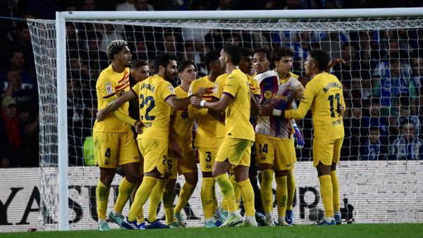 Barcelona's Uruguayan defender #04 Ronald Araujo (L) and teammates celebrate victory at the end of the Spanish league football match between Real Sociedad and FC Barcelona at the Anoeta stadium in San Sebastian on November 4, 2023. Barcelona won 0-1. (Photo by ANDER GILLENEA / AFP)