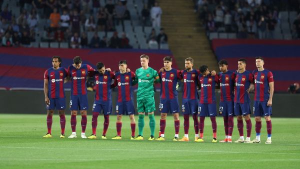 Players observe a minute of silence in tribute to late Argentinian coach Cesar Luis Menotti prior the Spanish league football match between FC Barcelona and Real Sociedad at the Estadi Olimpic Lluis Companys in Barcelona on May 13, 2024. (Photo by LLUIS GENE / AFP)