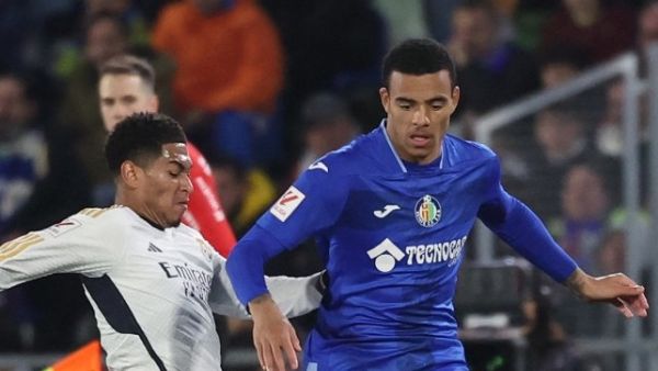 Real Madrid's English midfielder #5 Jude Bellingham vies with Getafe's British forward #12 Mason Greenwood during the Spanish league football match between Getafe CF and Real Madrid CF at the Coliseum Alfonso Perez stadium in Getafe on February 1, 2024. (Photo by Pierre-Philippe MARCOU / AFP)