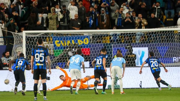 Inter Milan's Turkish midfielder #20 Hakan Calhanoglu shoots to score his team's second goal during the Italian Super Cup semi-final football match between Inter and Lazio at Al-Awwal Park Stadium in Riyadh, on January 19, 2024. (Photo by Fayez NURELDINE / AFP)