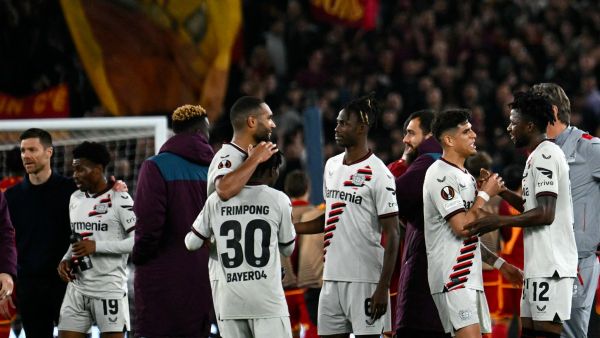 Bayer Leverkusen players congratulate each other after winning 0-2 the UEFA Europa League semi final first leg football match between AS Roma and Bayer Leverkusen at the Olympic stadium on May 2, 2024 in Rome. (Photo by Alberto PIZZOLI / AFP)