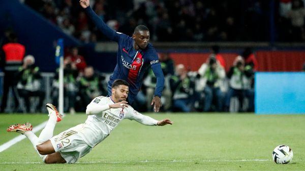 Lyon's Brazilian defender #21 Henrique Silva Milagres (L) fights for the ball with Paris Saint-Germain's French forward #23 Randal Kolo Muani during the French L1 football match between Paris Saint-Germain (PSG) and Olympique Lyonnais (Lyon) at the Parc des Princes stadium in Paris on April 21, 2024. (Photo by Guillaume BAPTISTE / AFP)