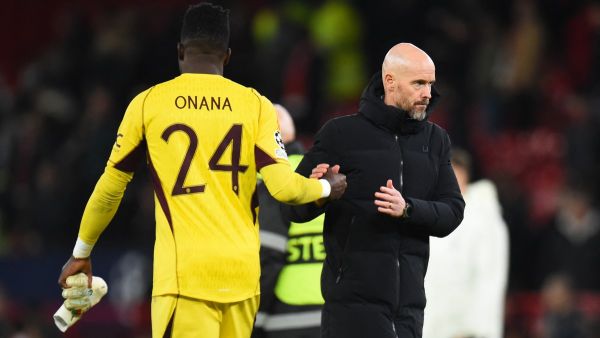 Manchester United's Dutch manager Erik ten Hag shakes hands with Manchester United's Cameroonian goalkeeper #24 Andre Onana after the UEFA Champions League group A football match between Manchester United and FC Bayern Munich at Old Trafford stadium in Manchester, north west England, on December 12, 2023. (Photo by PETER POWELL / AFP)