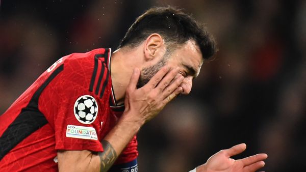 Manchester United's Portuguese midfielder #08 Bruno Fernandes reacts in pain during the UEFA Champions League group A football match between Manchester United and FC Bayern Munich at Old Trafford stadium in Manchester, north west England, on December 12, 2023. (Photo by PETER POWELL / AFP)