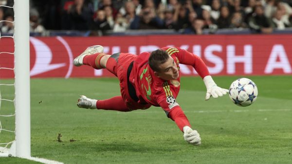 Real Madrid's Ukrainian goalkeeper #13 Andriy Lunin stops the ball during the UEFA Champions League group C football match between Real Madrid CF and SC Braga at the Santiago Bernabeu stadium in Madrid on November 8, 2023. (Photo by Thomas COEX / AFP)