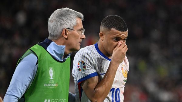 France's forward #10 Kylian Mbappe is escorted off the pitch for treatment during the UEFA Euro 2024 Group D football match between Austria and France at the Duesseldorf Arena in Duesseldorf on June 17, 2024. (Photo by PATRICIA DE MELO MOREIRA / AFP)