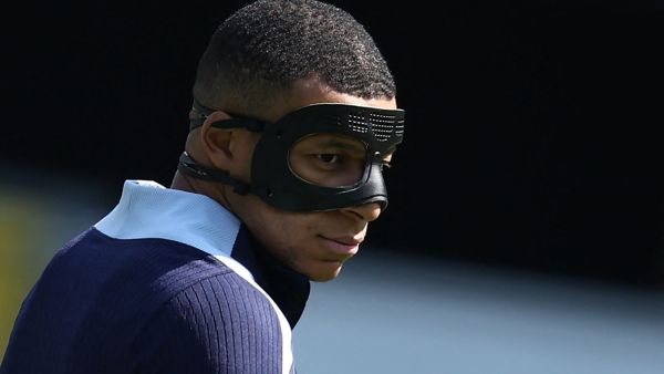 France's forward #10 Kylian Mbappe, wearing a protective mask, takes part in a MD-1 training session at the Home Deluxe Arena Stadium in Paderborn, western Germany, on June 24, 2024, on the eve of their UEFA Euro 2024 Group D football match against Poland. (Photo by FRANCK FIFE / AFP)