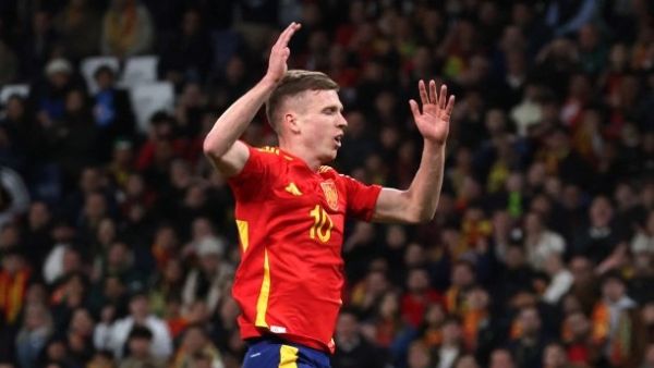 Spain's midfielder #10 Dani Olmo (up) celebrates scoring his team's second goal during the international friendly football match between Spain and Brazil at the Santiago Bernabeu stadium in Madrid, on March 26, 2024. Spain arranged a friendly against Brazil at the Santiago Bernabeu under the slogan "One Skin" to help combat racism. (Photo by Pierre-Philippe MARCOU / AFP)