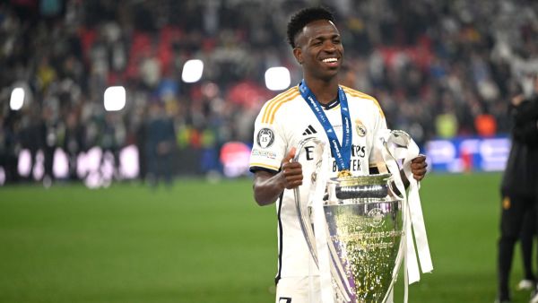 Real Madrid's Brazilian forward #07 Vinicius Junior poses with the trophy to celebrate the victory at the end of the UEFA Champions League final football match between Borussia Dortmund and Real Madrid, at Wembley stadium, in London, on June 1, 2024. (Photo by INA FASSBENDER / AFP)