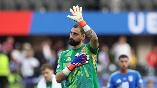 Italy's goalkeeper #01 Gianluigi Donnarumma waves to supporters at the end of the UEFA Euro 2024 round of 16 football match between Switzerland and Italy at the Olympiastadion Berlin in Berlin on June 29, 2024. (Photo by Ronny HARTMANN / AFP)