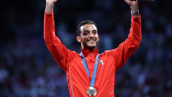 Bronze medallist Egypt's Mohamed Elsayed celebrates on the podium during the medal ceremony for the men's epee individual competition during the Paris 2024 Olympic Games at the Grand Palais in Paris, on July 28, 2024. (Photo by Franck FIFE / AFP)
