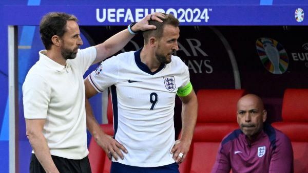 England's head coach Gareth Southgate and England's forward #09 Harry Kane stand near the substitutes' bench during the UEFA Euro 2024 quarter-final football match between England and Switzerland at the Duesseldorf Arena in Duesseldorf on July 6, 2024. (Photo by INA FASSBENDER / AFP)