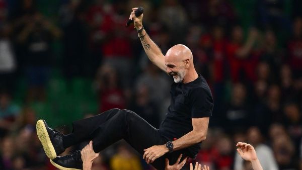 AC Milan's Italian coach Stefano Pioli is celebrated by AC Milan’s players at the end of the Italian Serie A football match between AC Milan and Salernitana at San Siro Stadium, in Milan on May 25, 2024. (Photo by MARCO BERTORELLO / AFP)