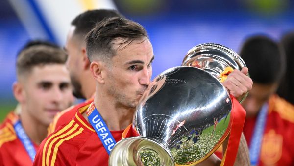 Spain's midfielder #08 Fabian Ruiz celebrates with the trophy after winning the UEFA Euro 2024 final football match between Spain and England at the Olympiastadion in Berlin on July 14, 2024. (Photo by Kirill KUDRYAVTSEV / AFP)