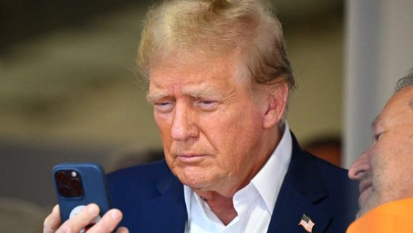 Donald Trump holding phone 
